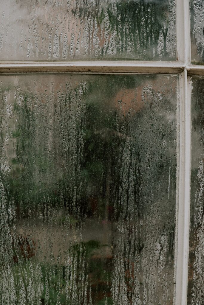 Condensation running down the inside of a single-glazed window